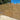 Contemporary slatted wooden fence panels that come in a range of sizes installed in a garden