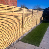 A contemporary garden with 6ft x 6ft slatted fencing down the side of the garden