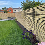 Installed double sided slatted fence panel 