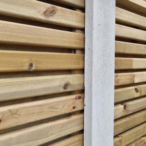 Slatted fence panels connected with concrete posts