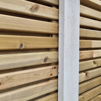 Slatted fence panels connected with concrete posts