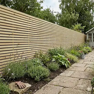 Modern horizontal treated fence panels in garden